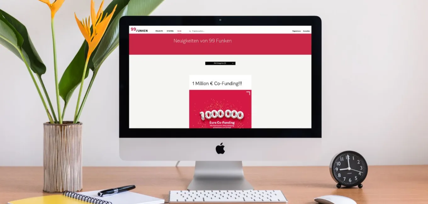 Auf einem Bildschirm ist der Browser geöffnet und zeigt die Website 99 Funken an.